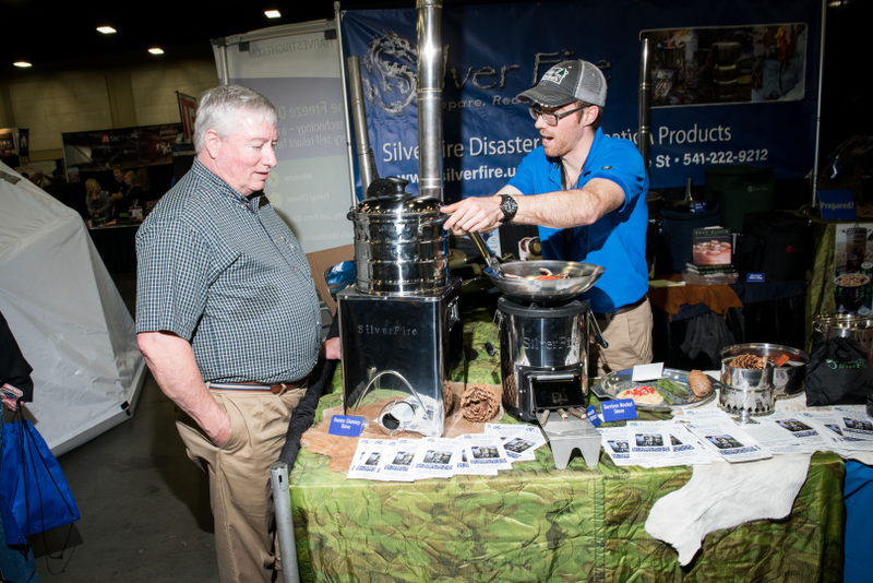 SilverFire vendor specializing in off-grid stoves, “biomass grills” and solar cookers at PrepperCon. Photo: Russel Daniels for Gizmodo